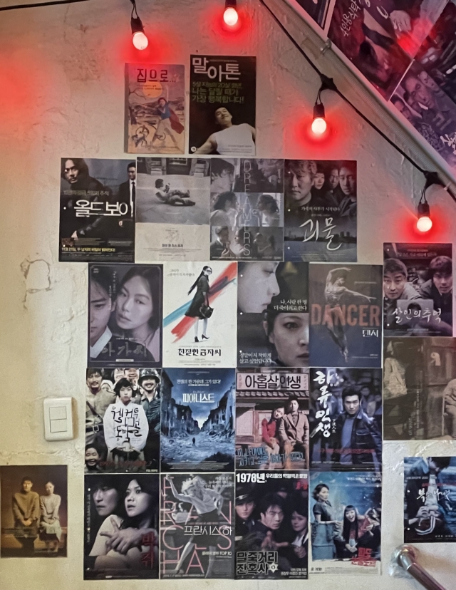 Movie posters are displayed on a wall in Tajagi (Moon Ki-hoon/The Korea Herald)