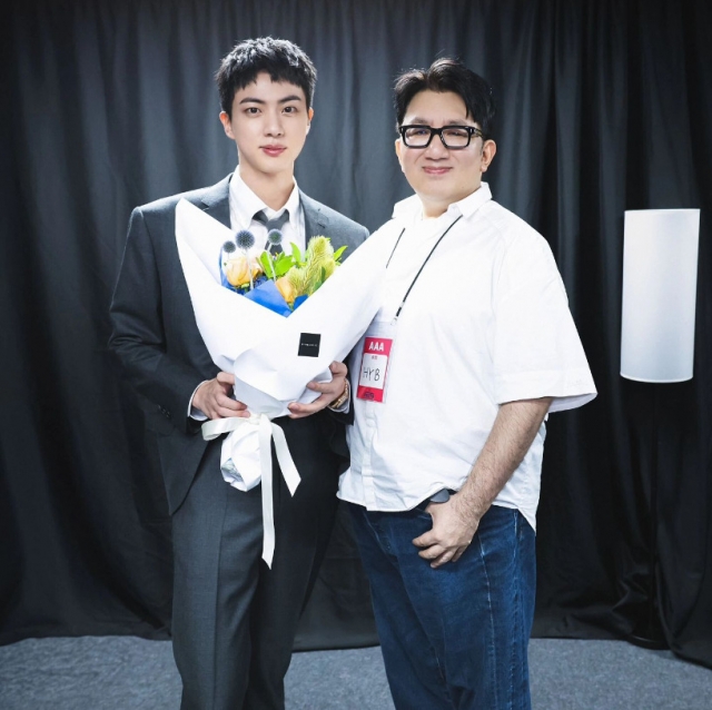 Jin of BTS (left) and Hybe Chairman Bang Si-hyuk pose at the backstage of 2024 Festa held in Seoul, on June 13. (Bang's Instagram account)