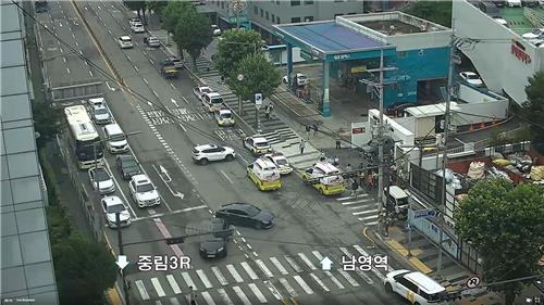 This image from surveillance camera footage shows the scene after a car accident that injured two pedestrians on a road near Seoul Station in central Seoul on July 6, 2024. (Yonhap)