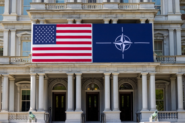 A view of the US flag alongside the NATO flag outside the Eisenhower Executive Office Building in Washington, US, Monday. (Reuters-Yonhap)