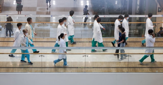 Medical workers walk in a hallway at a general hospital in Seoul on Monday. (Yonhap)