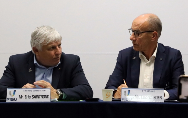 FISU President Leonz Eder converses with Secretary General Eric Saintrond during a press conference at Sejong City Hall on Tuesday. (Yonhap)