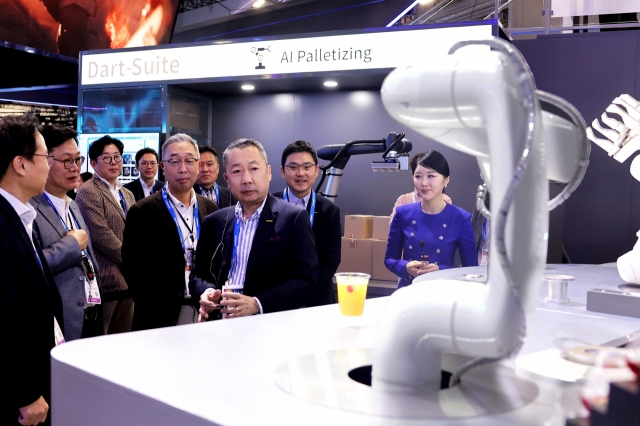 Doosan Group Chairman Park Jeong-won (third from right) looks around Doosan’s exhibition at CES 2024 in Las Vegas in January. (Doosan Group)