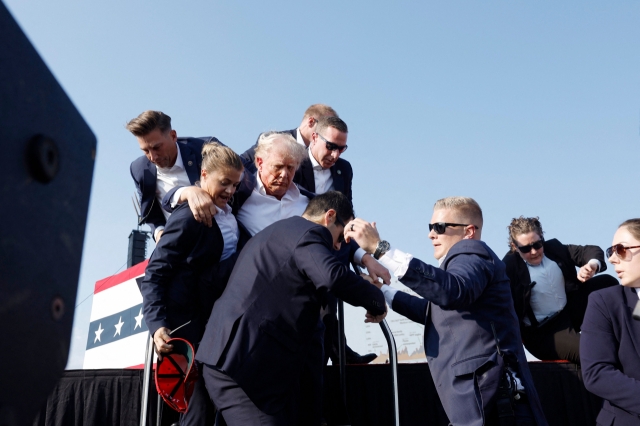 Republican presidential candidate former President Donald Trump is rushed offstage during a rally on Saturday in Butler, Pennsylvania. (AFP-Yonhap)