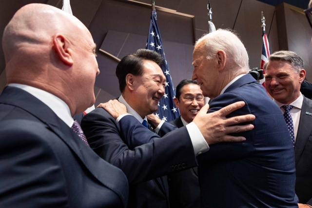 Prime Minister of New Zealand Christopher Luxon (from left), President Yoon Suk Yeol, Japanese Prime Minister Fumio Kishida, US President Joe Biden and Australia's Deputy Prime Minister Richard Marles are seen as Biden greets leaders of North Atlantic Treaty Organization's 