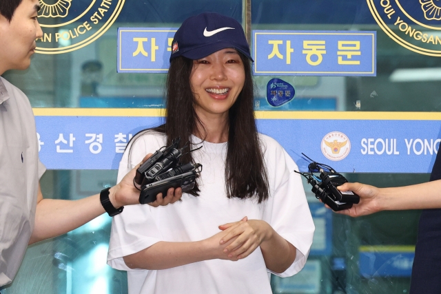 Ador CEO Min Hee-jin responds to reporters' questions as she leaves Yongsan Police Station in Seoul after being investigated as a suspect on a breach of trust charge, on July 9. (Newsis)