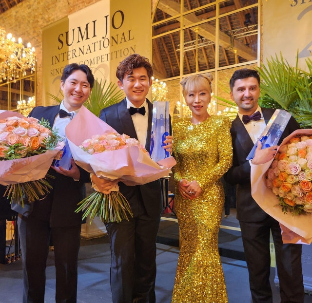 Sumi Jo (third from left), Li Zihao (second from left) and two other winners of the inaugural Sumi Jo Vocal Competition pose for photos at the Chateau de la Ferte-Imbault in France on Saturday. (Yonhap)