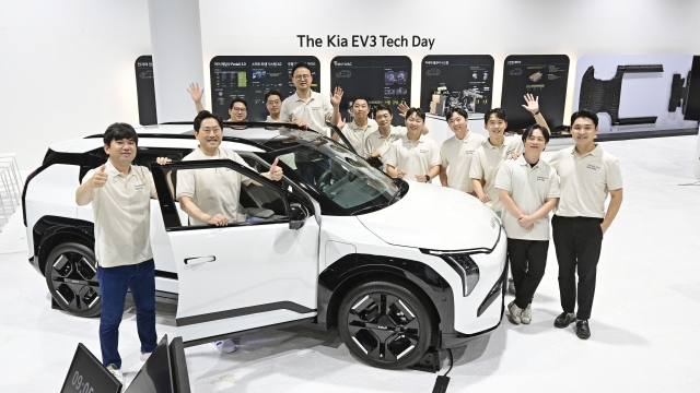 Kia engineers pose for a photo with the Kia EV3 at a studio in Seoul on Tuesday. (Hyundai Motor Group)