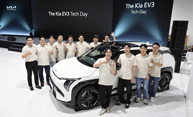 Kia engineers pose for a photo with the Kia EV3 at a studio in Seoul on Tuesday. (Hyundai Motor Group)