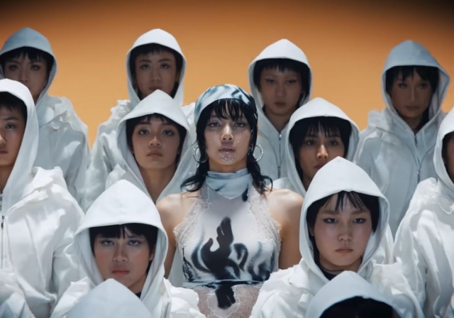 Lisa (center) of Blackpink is seen in a controversial scene in her music video for 