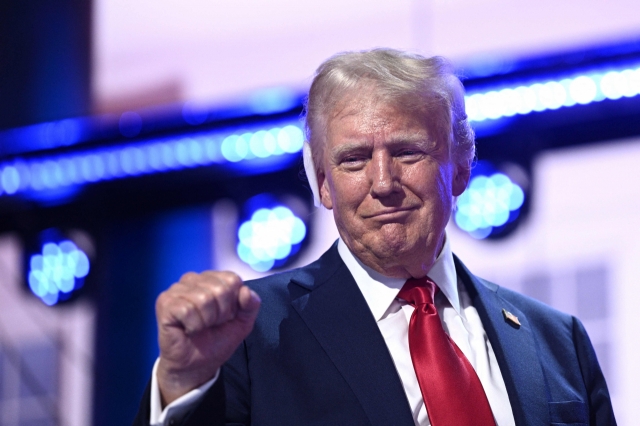 US former President and 2024 Republican presidential candidate Donald Trump holds up a fist onstage during the last day of the 2024 Republican National Convention at the Fiserv Forum in Milwaukee, Wisconsin, on Thursday. (AFP-Yonhap)