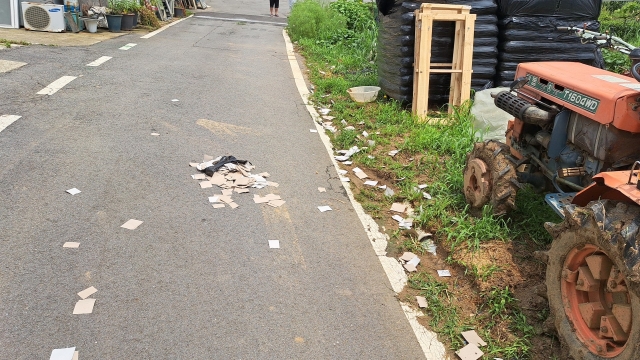 Remnants inside North Korea's batch of balloons presumed to be carrying trash are seen on the streets of Paju, Gyeonggi Province, Sunday. (Joint Chiefs of Staff)