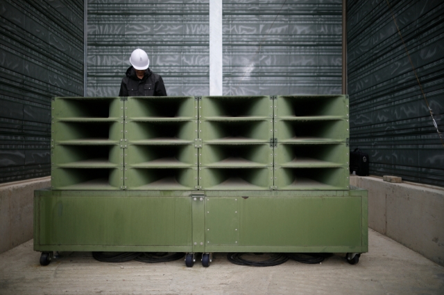 A worker dismantles loudspeakers set up for propaganda broadcasts near the demilitarized zone in Paju, South Korea, on May 1, 2018. (AP-Yonhap)