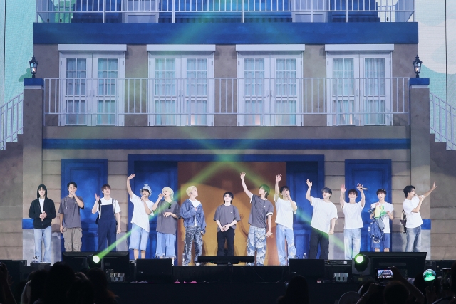 The bandmates of Seventeen wave to fans during a fan meeting at Gocheok Sky Dome in Seoul on Wednesday. (Pledis Entertainment)