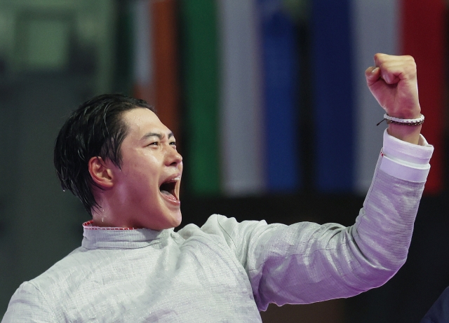 Oh Sang-uk of South Korea (L) celebrates after winning the gold medal in the men's individual sabre fencing event at the Paris Olympics at Grand Palais in Paris on Saturday. (Yonhap)