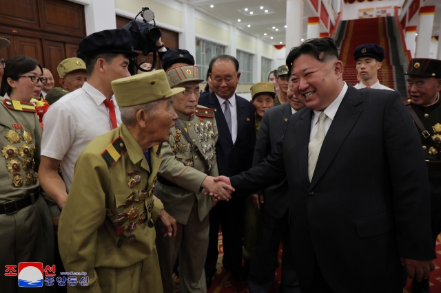 North Korean leader Kim Jong-un (center) meets with war veterans in an event, marking the 71st anniversary of the signing of the armistice that ended the 1950-53 Korean War, in Pyongyang on Saturday, in this photo released by the Korean Central News Agency the following day. (KCNA)