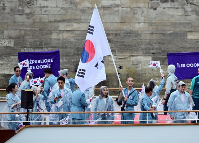 The South Korean delegation of athletes including flag bearers -- high jumper Woo Sang-hyeok (third from right, front) and swimmer Kim Seo-yeong (fourth from right, front) -- is seen on a boat sailing along the Seine River during the opening ceremony of the Paris 2024 Olympic Games on Friday. (Yonhap)