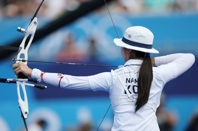 Nam Su-hyeon of the South Korean women's archery team, which achieved a 10th consecutive Olympic victory on Sunday, releases her arrow during the women's team archery final at the Les Invalides archery range in Paris, France, Sunday. (Yonhap)