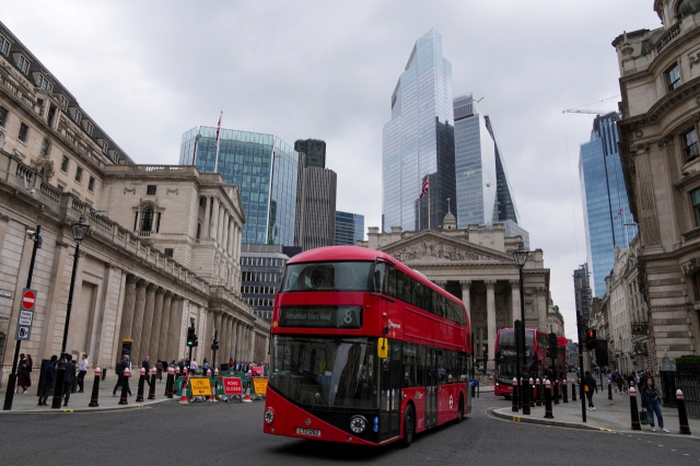 Buses go past the Bank of England building, in London, Britain July 3. (Reuters-Yonhap)