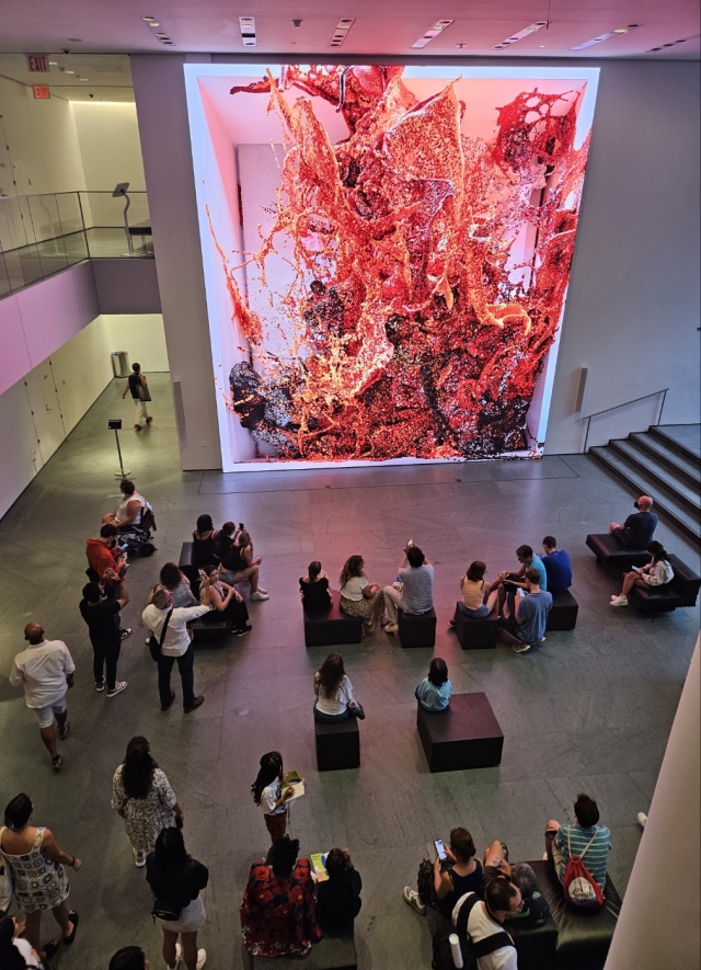 People watch Refik Anadol's work “Unsupervised” on Sept.10 at the Museum of Modern Art in New York. (Park Yuna/The Korea Herald)