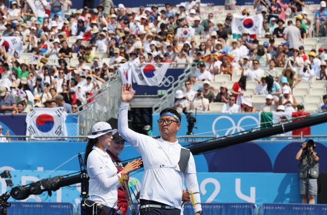 Lim Si-hyeon (left) and Kim Woo-jin of South Korea prepare for the start of the archery mixed team final against Germany at the Paris Olympics at Invalides in Paris on Friday. (Yonhap)