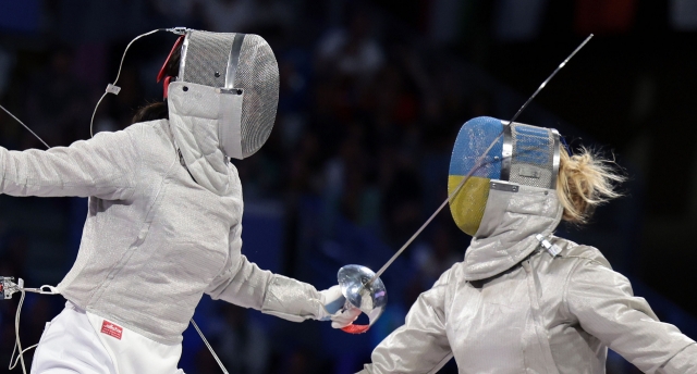 South Korea's Jeon Ha-young (left) battles Olga Kharlan of Ukraine during the women's sabre fencing team event at the Paris Olympics at Grand Palais in Paris on Saturday. (Yonhap)