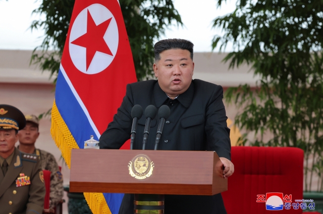 This photo, carried by North Korea's official Korean Central News Agency on Saturday, shows North Korean leader Kim Jong-un speaking during a visit to a helicopter unit dispatched to rescue isolated residents in flood-hit areas bordering China on Friday. (Yonhap)