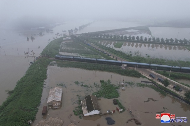 This undated photo, provided by North Korea's official Korean Central News Agency on July 31, shows flood-hit areas in Sinuiju, North Pyongan Province, as North Korean leader Kim Jong-un inspects the area. (Yonhap)