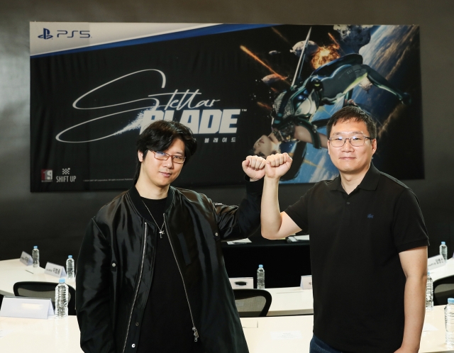 Kim Hyung-Tae (left), founder and CEO of Shift Up, and Lee Dong-ki, technical director, raise their fists at a press event for their console game “Stellar Blade” in April. (Shift Up)