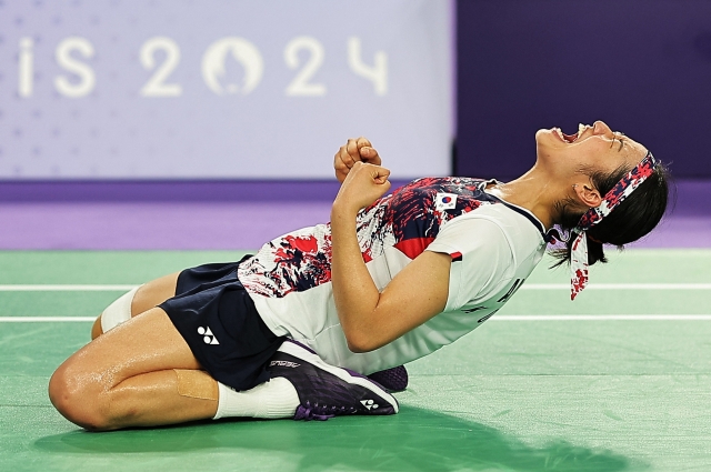 An Se-young of South Korea celebrates on the ground after winning gold in the match against Bing Jiao He of China at the 2024 Summer Olympics on Monday in Paris, France. (Reuters)