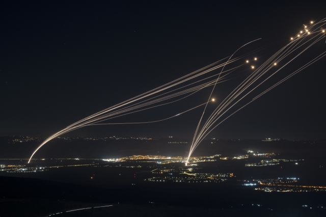 The Israeli Iron Dome air defense system fires to intercept an attack from Lebanon over the Galilee region as seen from the Israeli-annexed Golan Heights, on Sunday. (AP)