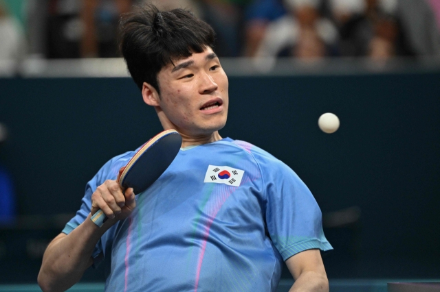 Jang Woo-jin plays a shot to Andrej Gacina of Croatia in the round of 16 of the men's table tennis team event at the Paris Olympics at South Paris Arena 4 in Paris on Tuesday (AFP-Yonhap)