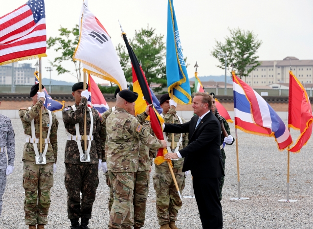 German Defense Minister Boris Pistorius (right) hands the German flag to Gen. Paul LaCamera (third from left), commander of the UN Command, during a ceremony marking Germany's admission into the multinational command at its headquarters in Pyeongtaek, 60 kilometers south of Seoul, on Friday. (Yonhap)