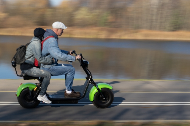 In this photo unrelated to the article, two people are seen riding on an electric scooter together. (123rf)