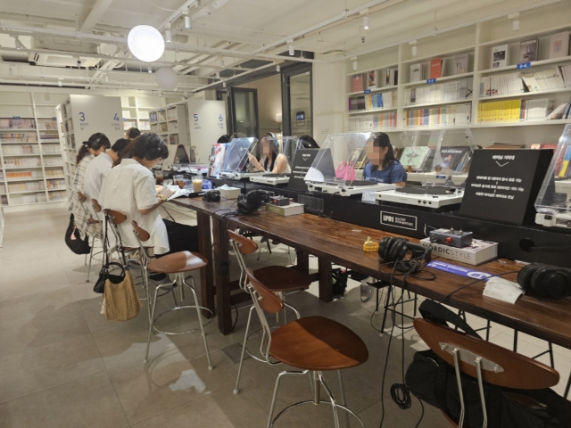 Customers are seen listening to vinyl in Akiba Comics. (Lee Yoon-seo/The Korea Herald)