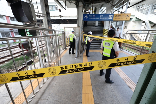 The Korea Railway Police secure the scene on Friday morning at Guro Station on Seoul Subway Line 1, where a collision between two maintenance vehicles killed two workers and seriously injured a third earlier in the day. (Yonhap)