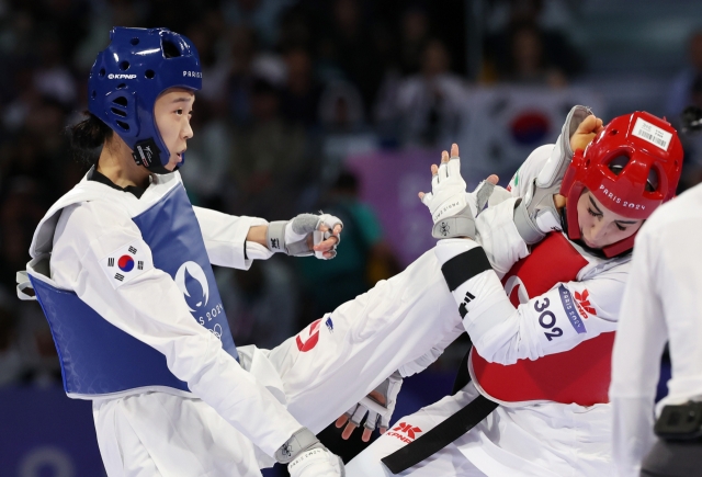 South Korea's Kim Yu-jin lands an attack on her opponent Nahid Kiani of Iran in the finals of the women's -57-kilogram taekwondo event at the Paris Olympics at Grand Palais in Paris on Thursday. (Yonhap)