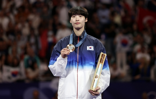 In this Reuters photo, Lee Da-bin of South Korea celebrates after winning bronze in the women's +67-kilogram taekwondo event at the Paris Olympics at Grand Palais in Paris on Saturday. (Yonhap)