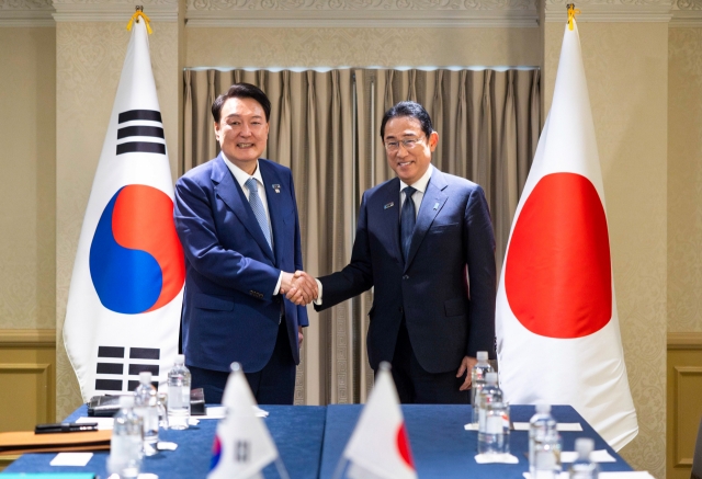 President Yoon Suk Yeol (left) and Japanese Prime Minister Fumio Kishida shake hands during their meeting in Washington, D.C., on July 10, 2024, on the sidelines of the North Atlantic Treaty Organization summit. (Pool Photo via Newsis)