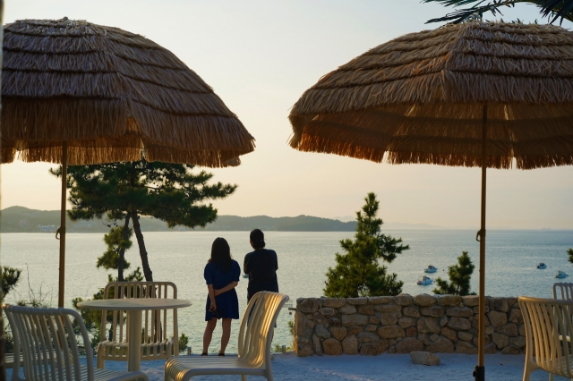 Guests wait to watch the sunset at Floredo Cafe on Seonjaedo, an island off Incheon on Aug. 11. (Lee Si-jin/The Korea Herald)