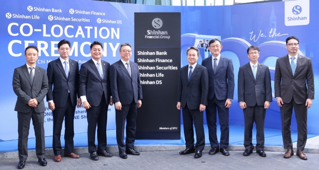 Shinhan Financial Group Chairman Jin Ok-dong (fourth from right) and Shinhan Bank CEO Jung Sang-hyuk (fourth from left) pose with local subsidiary heads at the opening ceremony of the group's new Vietnam headquarters on Thursday. (Shinhan Financial Group)