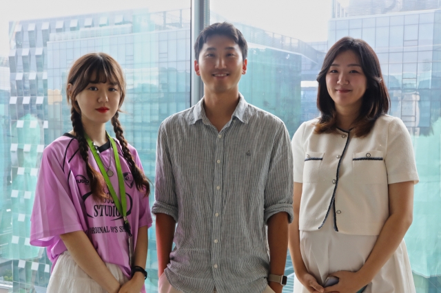 (From left) Managers at Naver Webtoon's AI planning team Kim Seong-eun, Kim Sung-hyun and Cha Yeon-ju pose for a photo at the Naver Webtoon headquarters in Pangyo, Gyeonggi Province, Aug. 8. (Naver Webtoon)