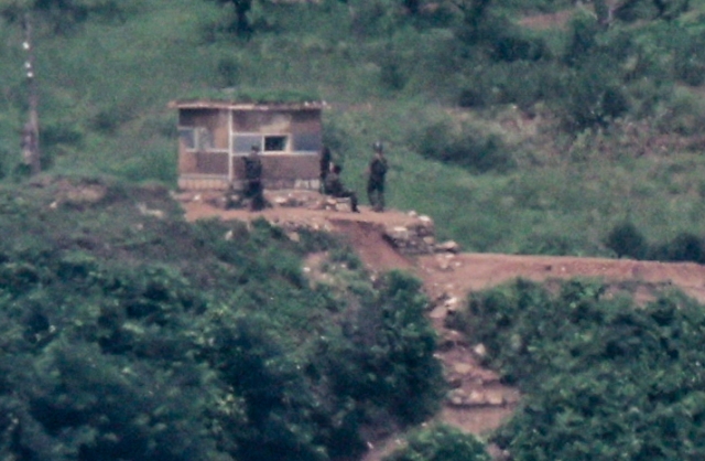 A North Korean soldier stands guard at a border outpost in this photo taken on July 21, from South Korea's border city of Paju, 37 kilometers northwest of Seoul. (Yonhap)