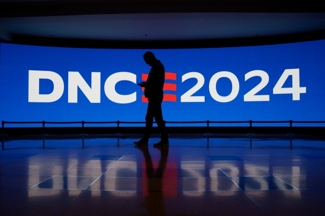 A member of staff passes a digital display at the United Center ahead of the Democratic National Convention in Chicago, Illinois, Saturday.