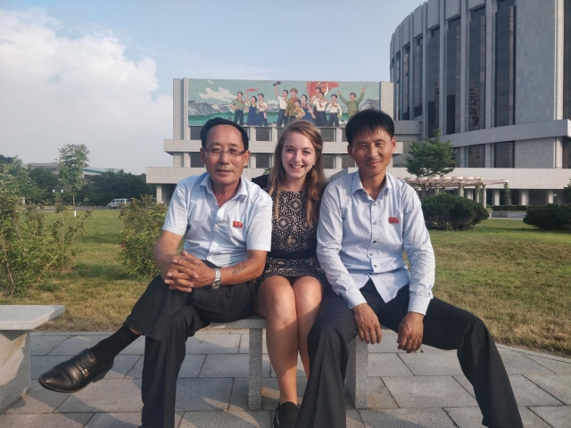 British traveler Zoe Stephens (center) poses for a photograph with North Korean drivers outside the circus in Pyongyang in 2019. (Zoe Stephens)