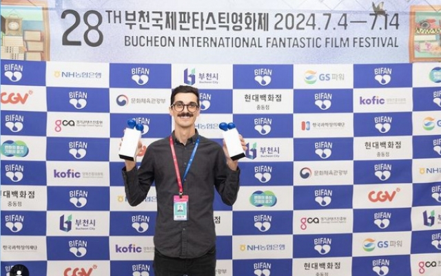 Francis Galluppi poses with the Best of Bucheon and audience awards at the Bucheon International Fantastic Film Festival, in Bucheon, Gyeonggi Province, July 12. (BIFAN)