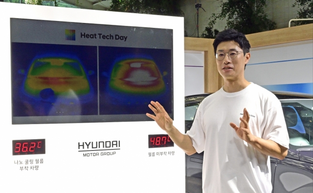 Lee Min-jae, a principal researcher from the energy component research team, explains the nano-cooling film technology on two Ioniq 6 test vehicles at Hyundai Motor Group's Heat Tech Day event on Thursday. (Hyundai Motor Group