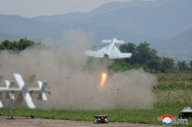 This photo shows the North holding a performance test of drones on Saturday under the guidance of leader Kim Jong-un. (KCNA)