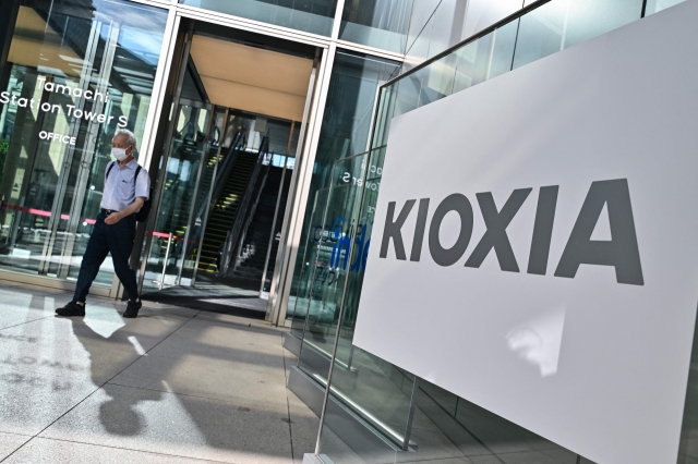 A man walks out of the headquarters of Kioxia, the world's third-largest manufacturer of NAND flash memory chips, in central Tokyo on Friday. (AFP-Yonhap)