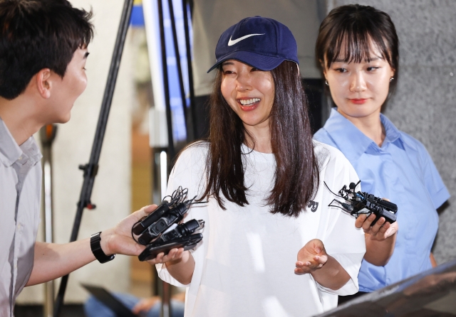 Former Ador CEO Min Hee-jin speaks to reporters while leaving Yongsan Police Station in Seoul on July 9, following questioning over her alleged breach of trust. (Newsis)